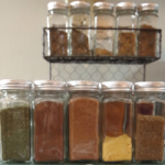 Glass spice jars filled with spices.